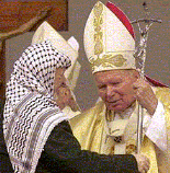 Palestinian leader Yasser Arafat embraces Pope